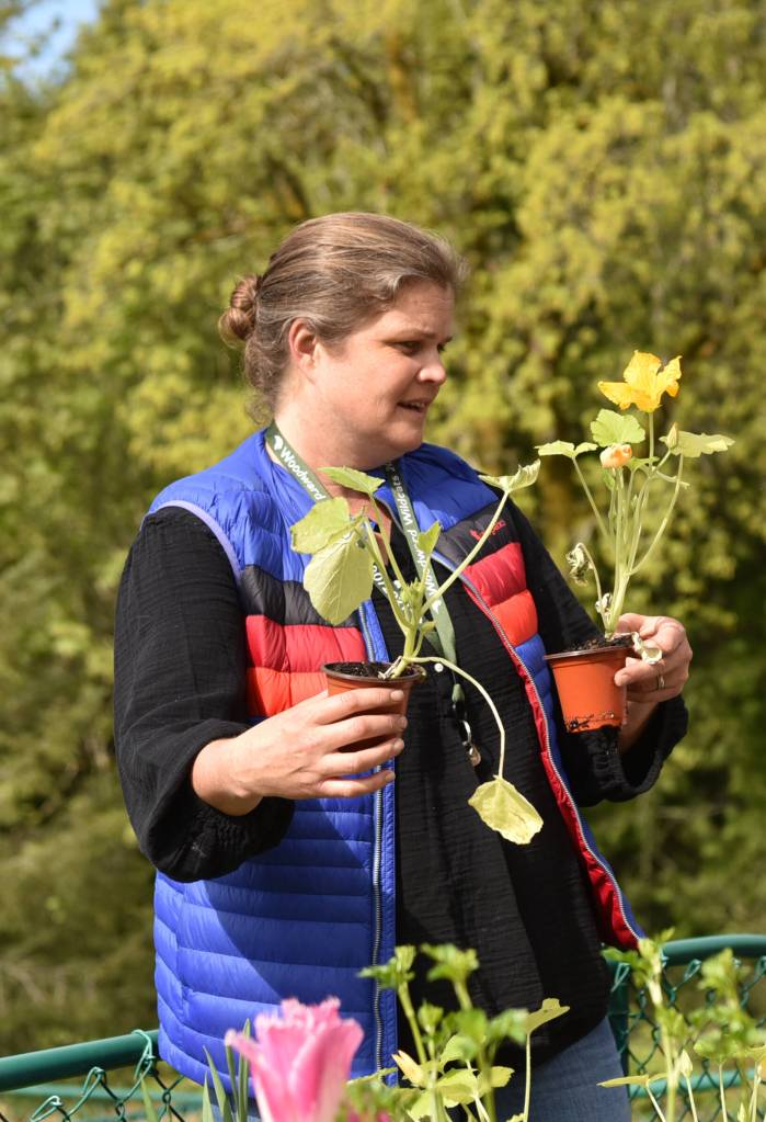 Teacher Meloni Courtway explaining how to prepare nursery plants for the garden.