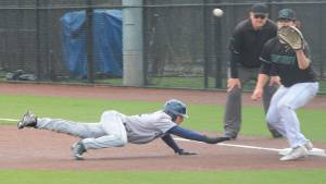 Bainbridge pinch runner Wyatt Olseon dives safely back to first in the game Saturday against Auburn. Steve Powell/Bainbridge Review photos