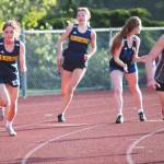 Spartan Claire Hungerford takes off as teammate Clara Maclise races to pass the baton to her on the 4 by 100 relay.