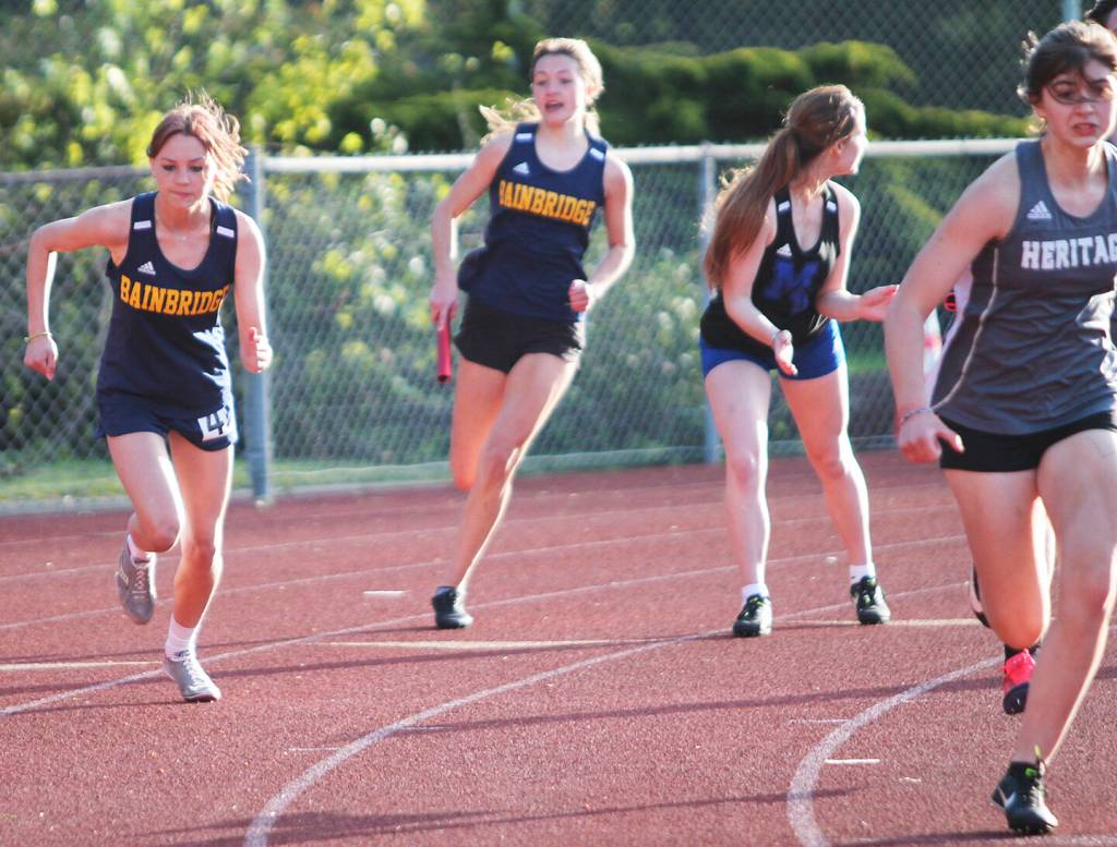 Spartan Claire Hungerford takes off as teammate Clara Maclise races to pass the baton to her on the 4 by 100 relay.