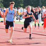 Matt LeDorze, center, of Bainbridge reaches for the finish line in the 100 meters. Steve Powell/Bainbridge Review photos