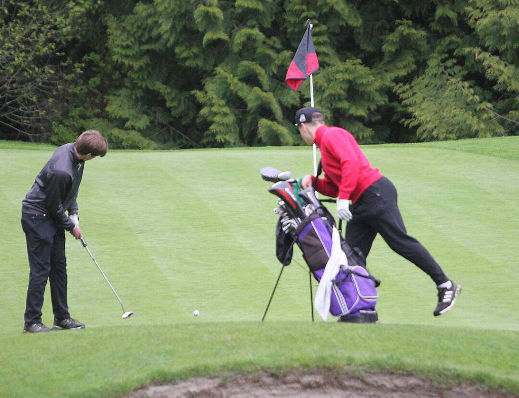 Mac McKinnon of North Kitsap, left, shot a round of 91.