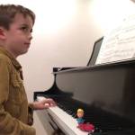 James Pearce Ullrich of Bainbridge Island performs his original composition on the baby grand piano at his home. Courtesy Photo