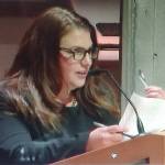 Planning Commissioner Ariel Birtley holds up a feather to symbolize giving a voice to animals that would be hurt by development. Steve Powell/Bainbridge Review