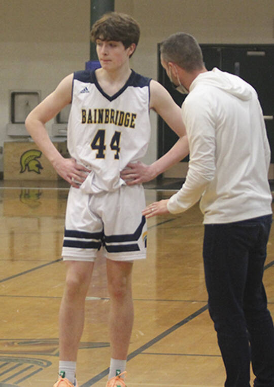 Coach Steve Haizlip talks with Noah Davis while the other team shoots free throws.