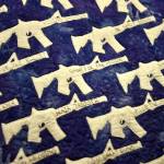 Fifty AR-15 silhouettes with gun idioms fill the field of blue on Naomi Spinak's Sweet Land Of Liberty quilt. Nancy Treder/Bainbridge Review