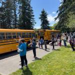 Teachers and parents say goodbye to kids on BI school buses as they depart on the last day of school.