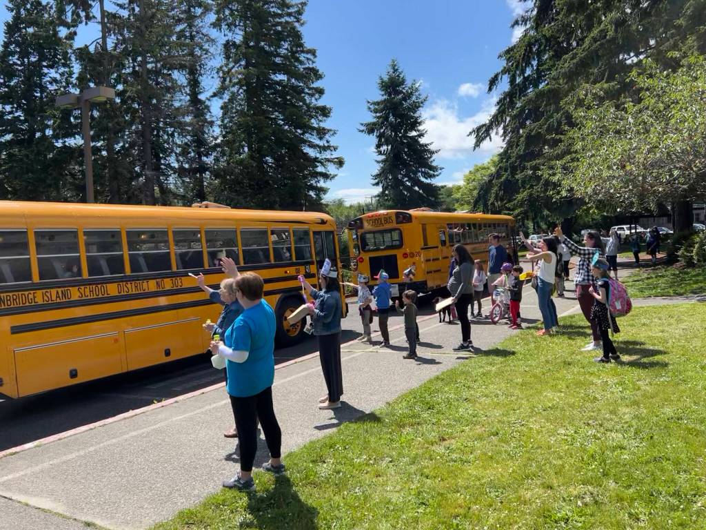 Teachers and parents say goodbye to kids on BI school buses as they depart on the last day of school.