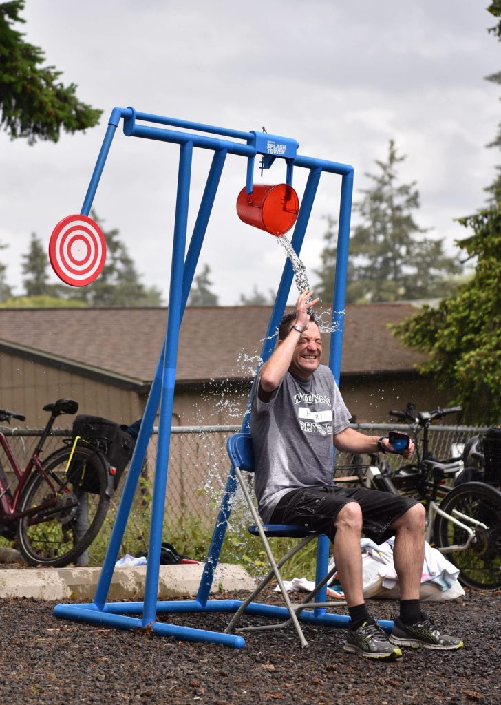 Woodward engineering teacher Tim Harris gets soaked in the Drench-your-teacher booth at the No-More-School-A-Palooza event at the Aquatics Center June 16.