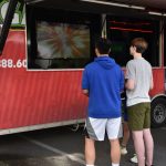 Two boys enjoyed video games at the game truck during the No-More-School-A-Palooza festival held in the Aquatics Center parking lot.