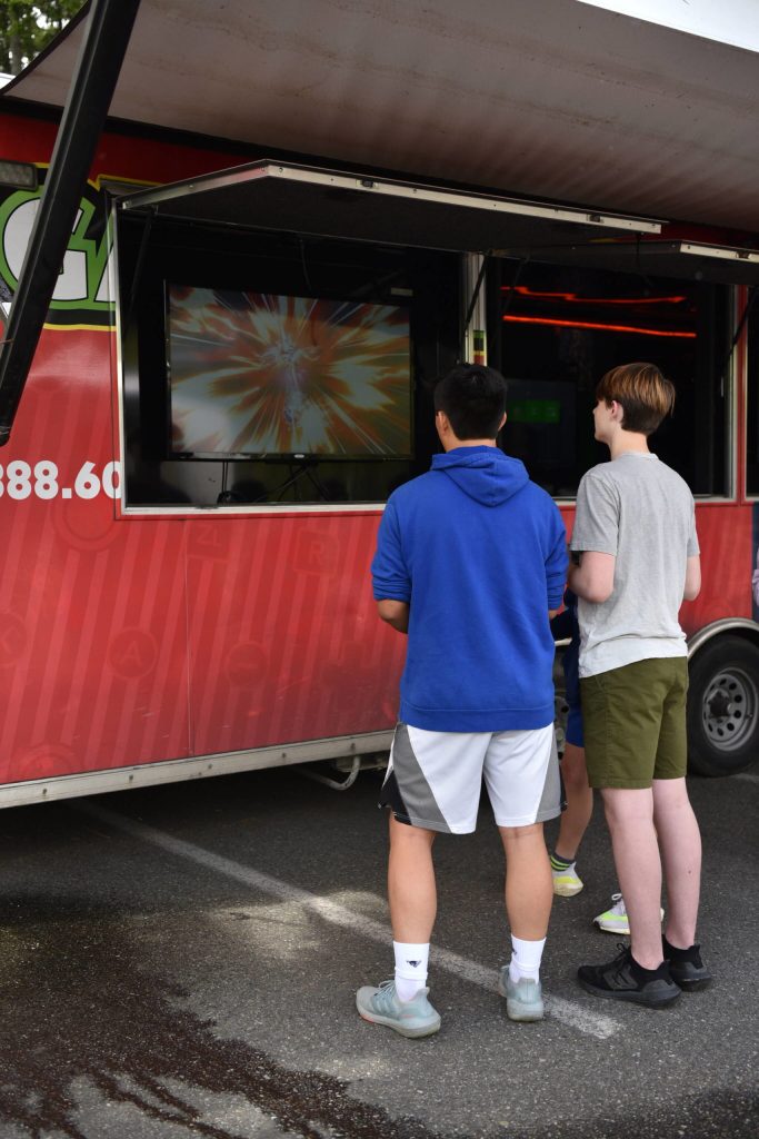Two boys enjoyed video games at the game truck during the No-More-School-A-Palooza festival held in the Aquatics Center parking lot.