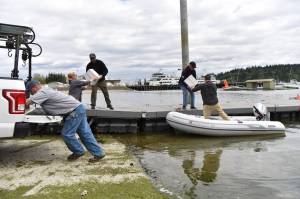 Volunteers help move boxes of emergency water from the flotilla boat, The Otter, to a city of Bainbridge Island truck at the public dock in Eagle Harbor. Nancy Treder/Bainbridge Island Review photos