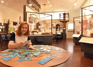 Nancy Treder/Bainbridge Island Review photos
Merilee Mostov putting puzzle pieces together in the Our Community: Past to Present exhibit at the Bainbridge Island Historical Museum.