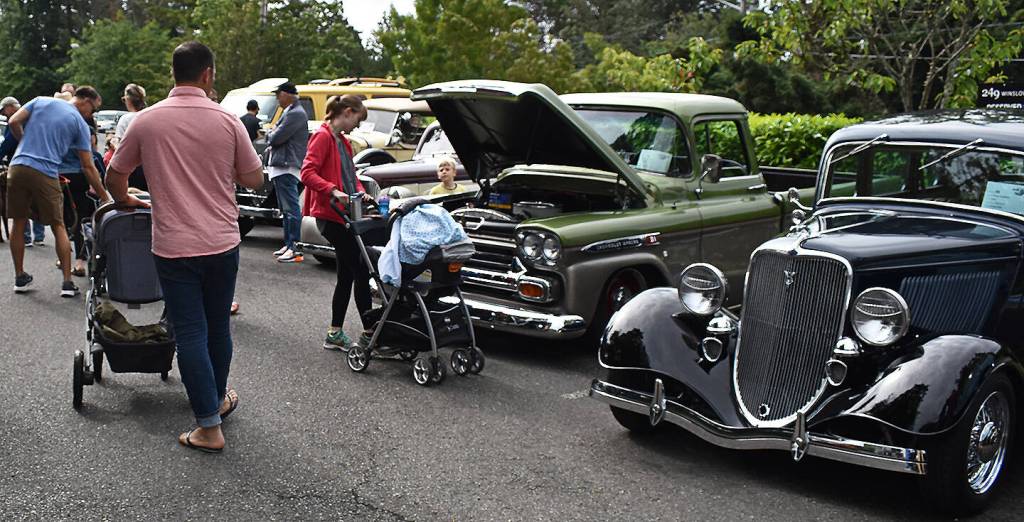 Families took part in observing and voting for the best car in the July 4 Car Show.