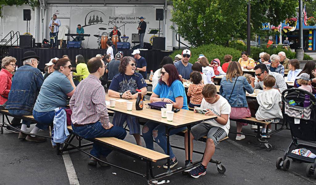 Families sat down after receiving a breakfast and listened to live music in the Town & Country parking lot.