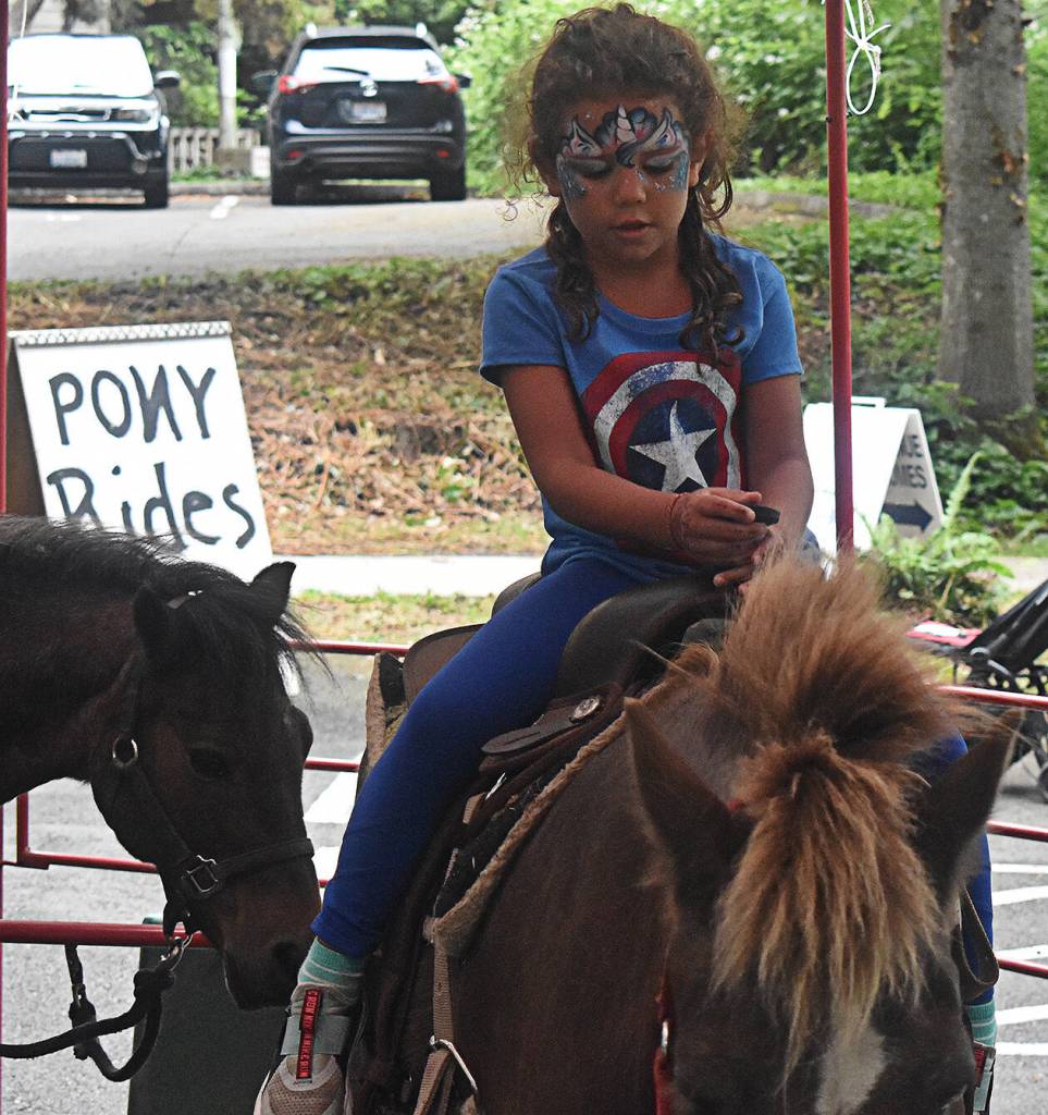 Kids saddled up for pony rides during the July 4 Street Fair.