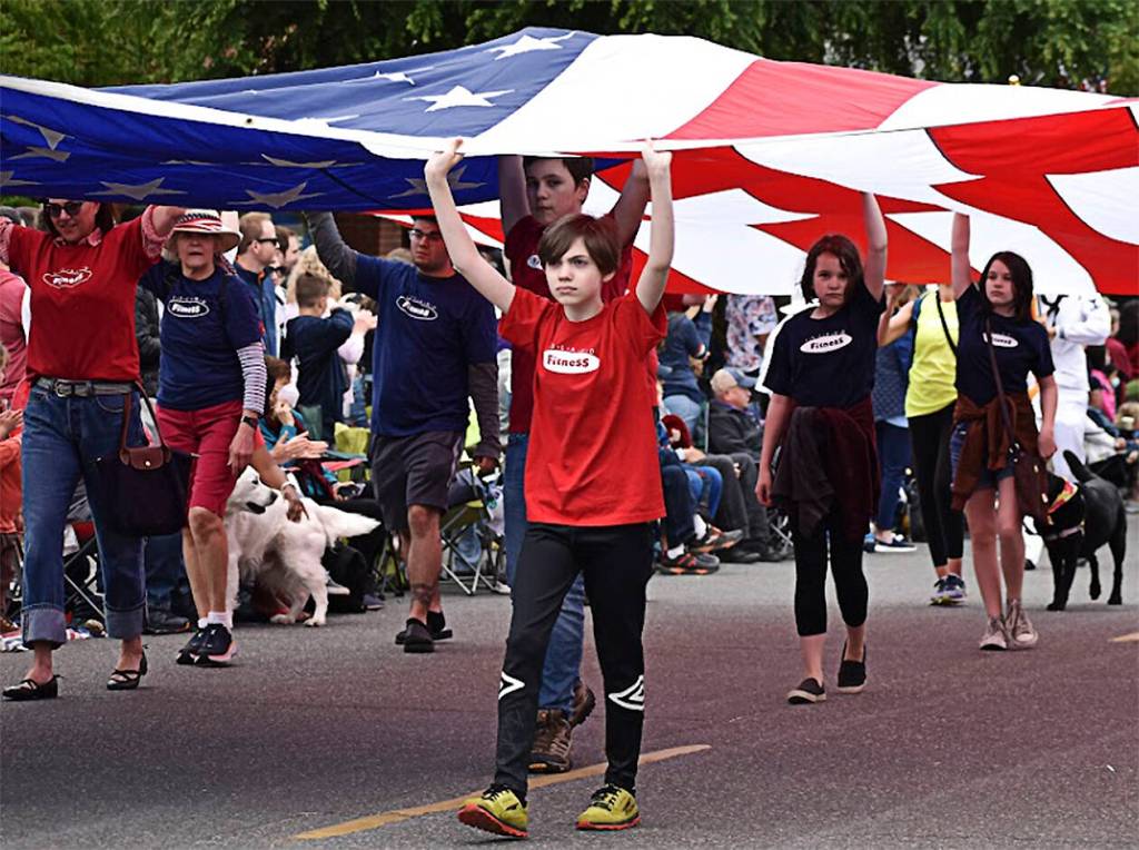 Members of Island Fitness walked with a large U.S. flag over their heads throughout the milelong parade.