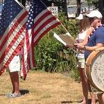 Participants march to the beat of a bass drum from the Sandspit to the park on the 4th.