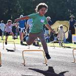 The kids compete by jumping over cute little hurdles.