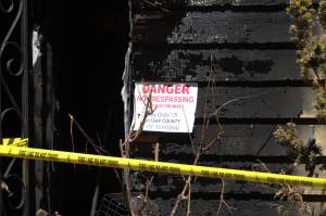 Signs posted by law enforcement surround the burned house.