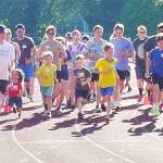 A larger group takes off in a race with folks of all ages.