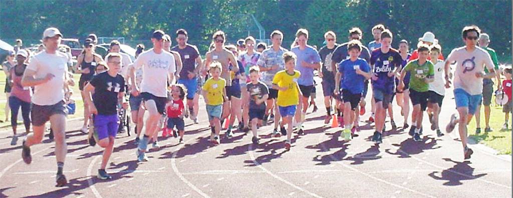 A larger group takes off in a race with folks of all ages.