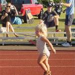 A young girl sprints to the finish line.