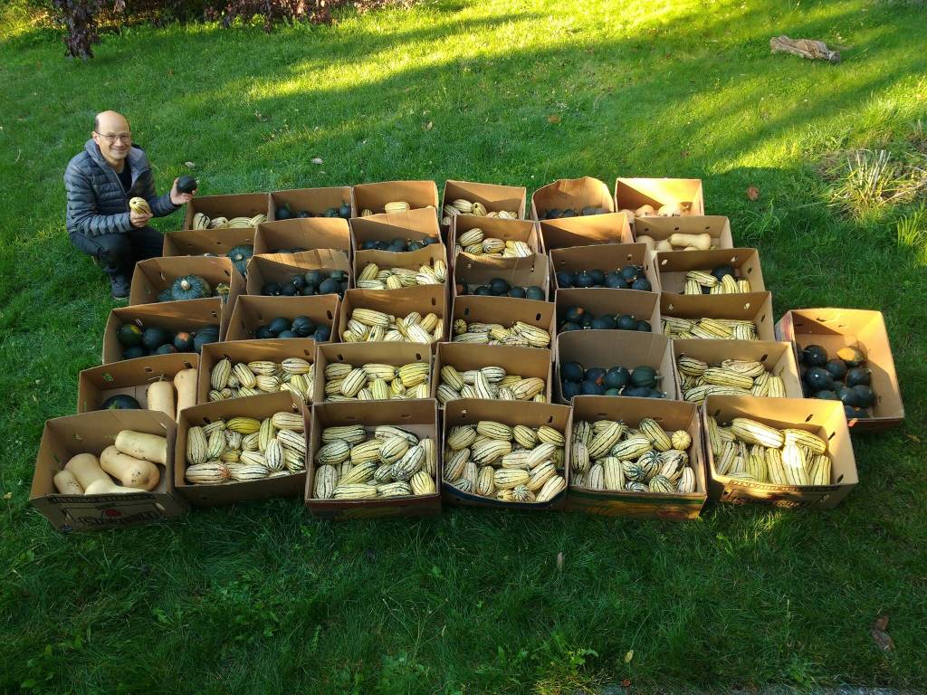 John Chang poses with boxes of produce ready for delivery to local food banks.