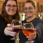 Nancy Treder/Bainbridge Island Review Photos
Above: Co-owners Randi Brown and Caron Anderson toast the opening of their new business, Sisters Cider House. Left: A colorful flight of cider offerings at Sisters Cider House.
