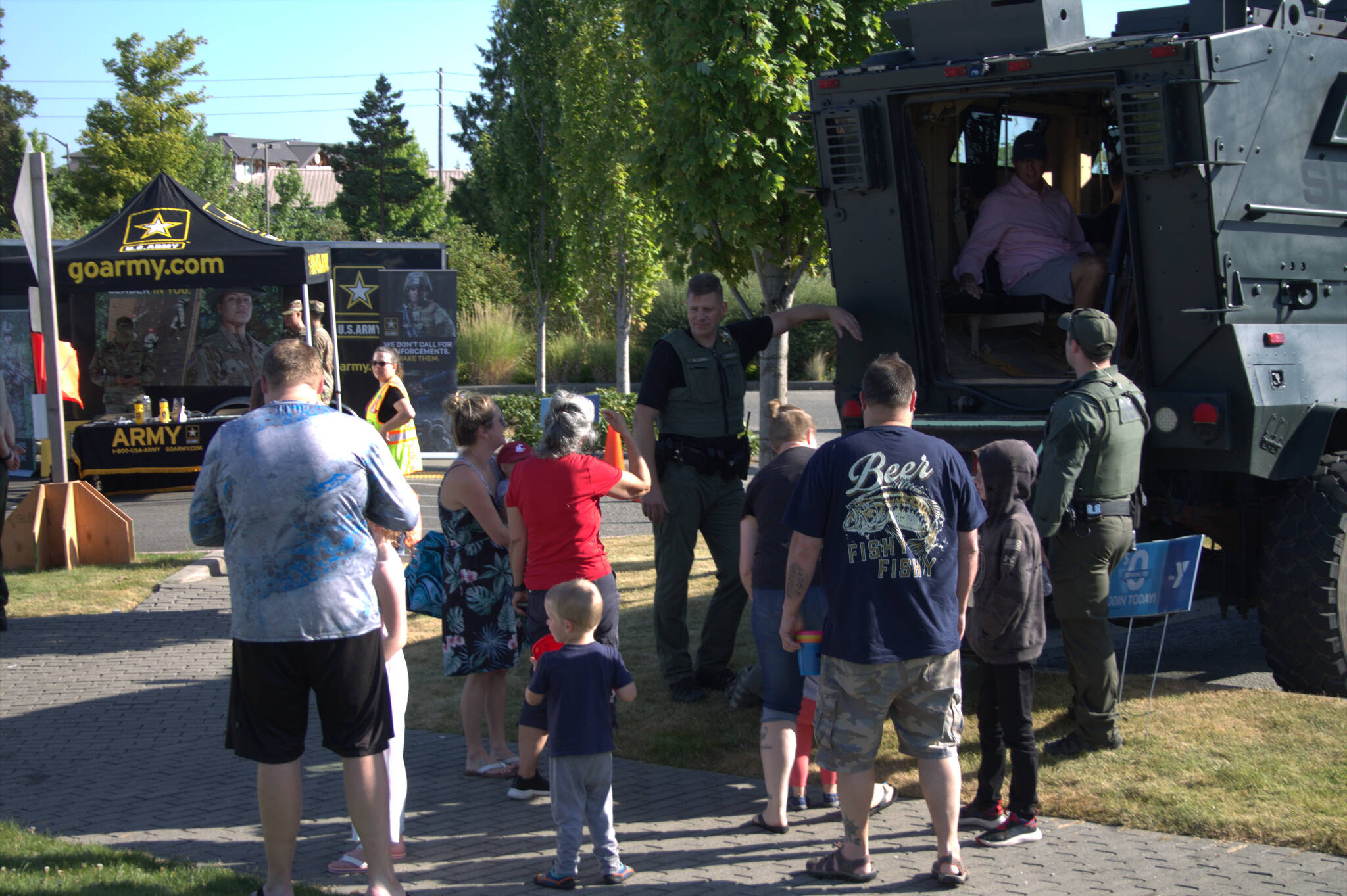 Families gather around a heavy-duty vehicle used by one of Kitsap Countys special units.