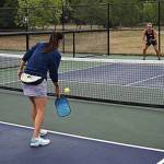 Tonja Major helps Theresa Collier, Marty Collier and Tim Phillips work on staggering positions in case the opponents return a hard-hit ball.
