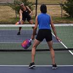 Tim Phillips and Theresa Collier practice hitting into the kitchen in order to work on reaction time and get better strategies.