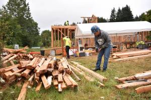 Volunteer Maureen McNulty pulls nails from repurposed lumber being used to build three tiny houses for the reHOME project at Morales Farm. The lumber is from the demolition of the old Harrison Medical Center, which is being converted into a police-court facility. The tiny homes will be used as living quarters for interns at the farm. McNulty is a teacher at Klahowya Secondary School in Silverdale. "I do what I can because we need a place for the interns, and we need more of them in farming to sustain ourselves." Nancy Treder/Bainbridge Island Review Photos