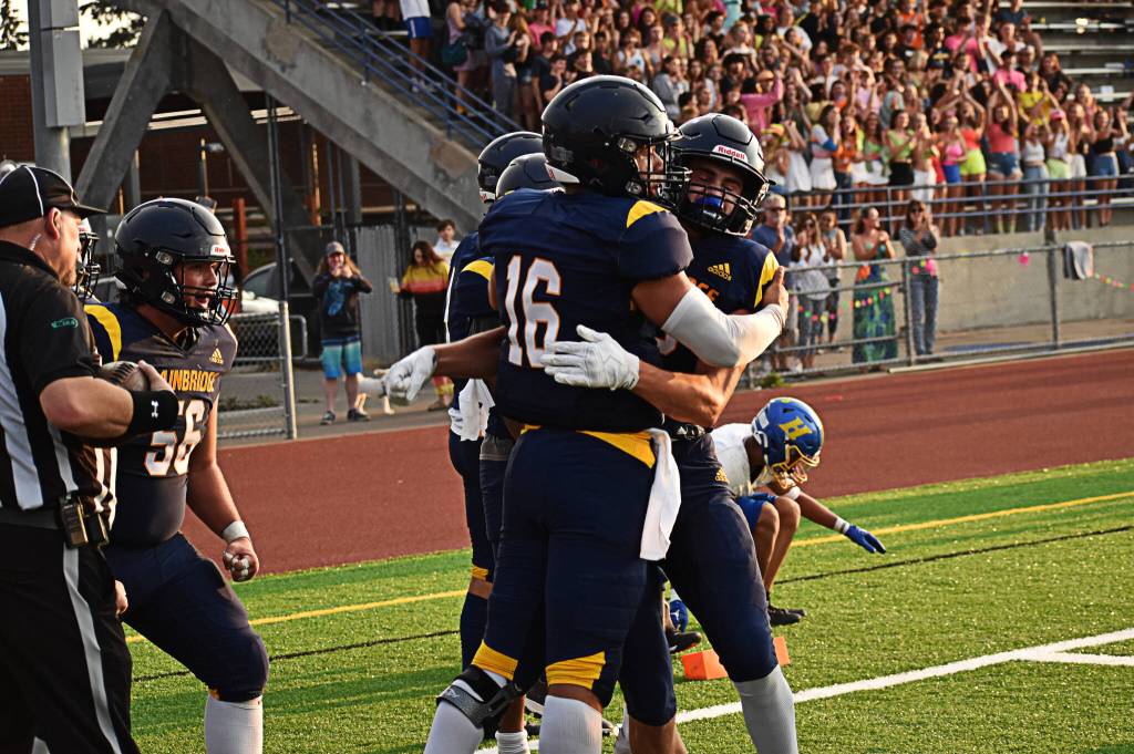 Jack Grant celebrates with teammates after the first touchdown of the season.