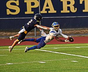 Johnny Breen reaches out to stop the Hazen wide receiver from making the catch. Nicholas Zeller-Singh/Bainbridge Island Review Photos