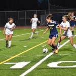 Bainbridges Hailey Fink pushes the ball to the attacking zone.
