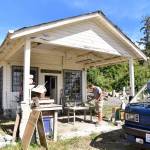 Stone sculptor, Ethan Currier, cleaning up outside his gallery after discovering the theft of his tools. Nancy Treder/Bainbridge Island Review Photos