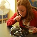 St. Cecilia eighth-grader Megan Zahumenshy conducts a bubble experiment on new lab tables in science class on the first day of school.
