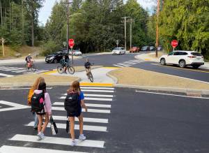 Students walk and cycle through the updated intersection at New Brooklyn and Sportsman Club roads on the morning of the first day of school Sept. 7. Nancy Treder/Bainbridge Island Review Photos