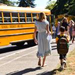 Ordway Elementary School second-grade teacher Vanessa Johnson escorts a student to the bus.