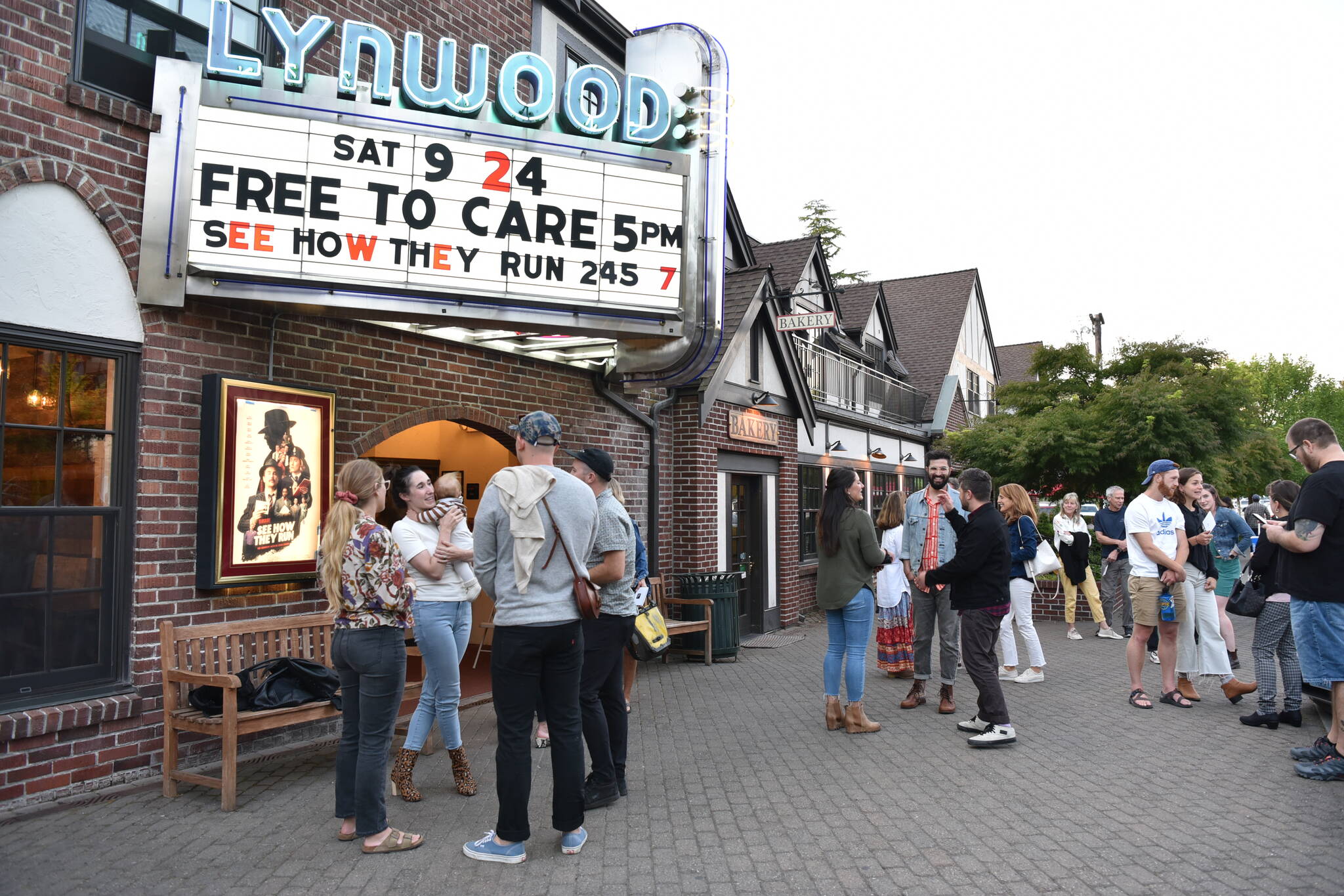 Moviegoers chat outside the Lynwood Theatre after the premiere of documentary, "Free to Care," produced by filmmakers Zach Ignasci and Chris Temple.