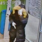 Surveillance video shows one of the robbers entering Kitsap Cannabis while appearing to draw a weapon. Courtesy Photos