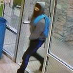The first of two robbers enter Kitsap Cannabis wearing heavy clothing and a face covering.