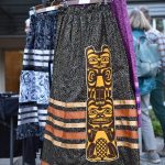 Ribbon skirts on display with a totem applique.