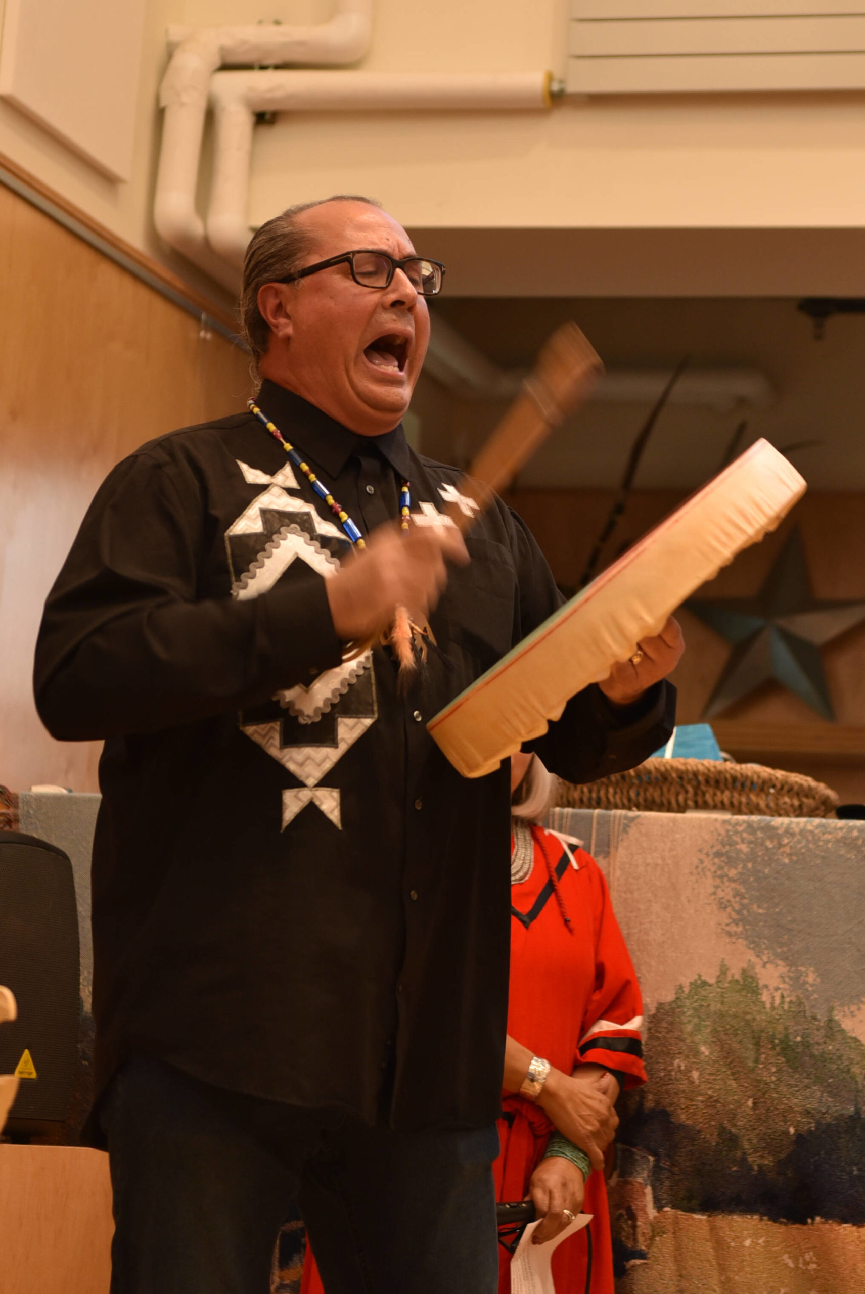 Joseph Martin, executive board chair for the Indipino community, sings an honor song dedicated to the 36 indigenous mothers who were the founders of the Indipino community on Bainbridge.