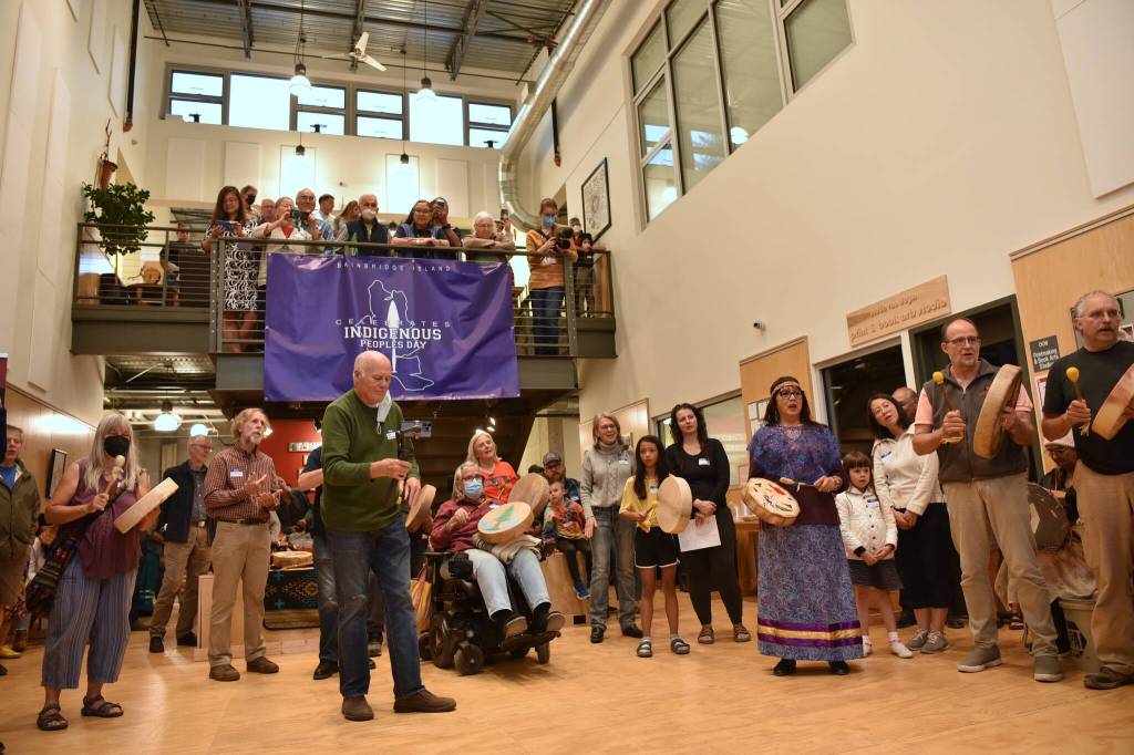 Bainbridge Island community members and tribal members of the BI Indipino Community, the Suquamish Tribe and the Squamish Nation in British Columbia gather and perform a welcome song with handmade traditional drums at BARN to celebrate Indigenous Peoples Day Oct. 10. Nancy Treder/Kitsap News Group Photos
