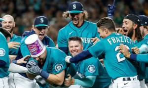 Cal Raleigh celebrates with his teammates after hitting a walk-off home run to send the Mariners to the postseason for the first time in 21 years. Getty Images Courtesy Photo