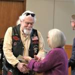 A veteran receives a congressional declaration with the pin.