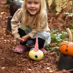 Lucy DeWitt finds a unicorn pumpkin on the trail at Bainbridge Gardens Oct. 23.
