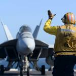 Stanley Sanchez directs an F/A-18E Super Hornet aboard the USS Nimitz. Courtesy Photos